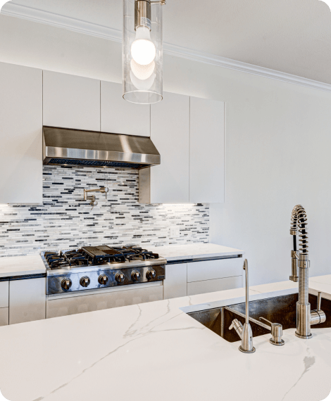 All white kitchen counter with metallic faucet