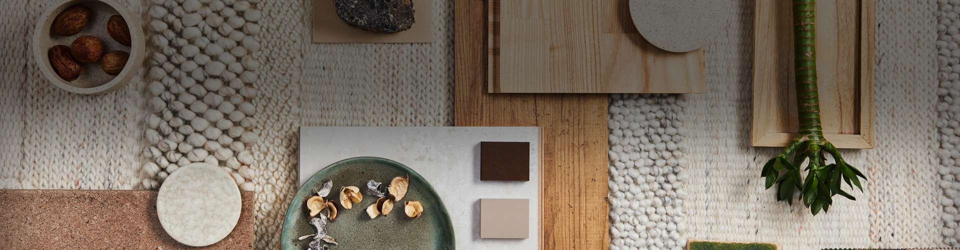 Flat lay design of creative architect moodboard composition with samples of building, beige textile and natural materials and personal accessories.